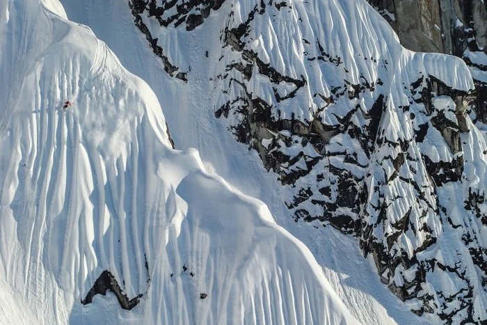 A skier committing to a steep face in the Chugach Mountains, Alaska