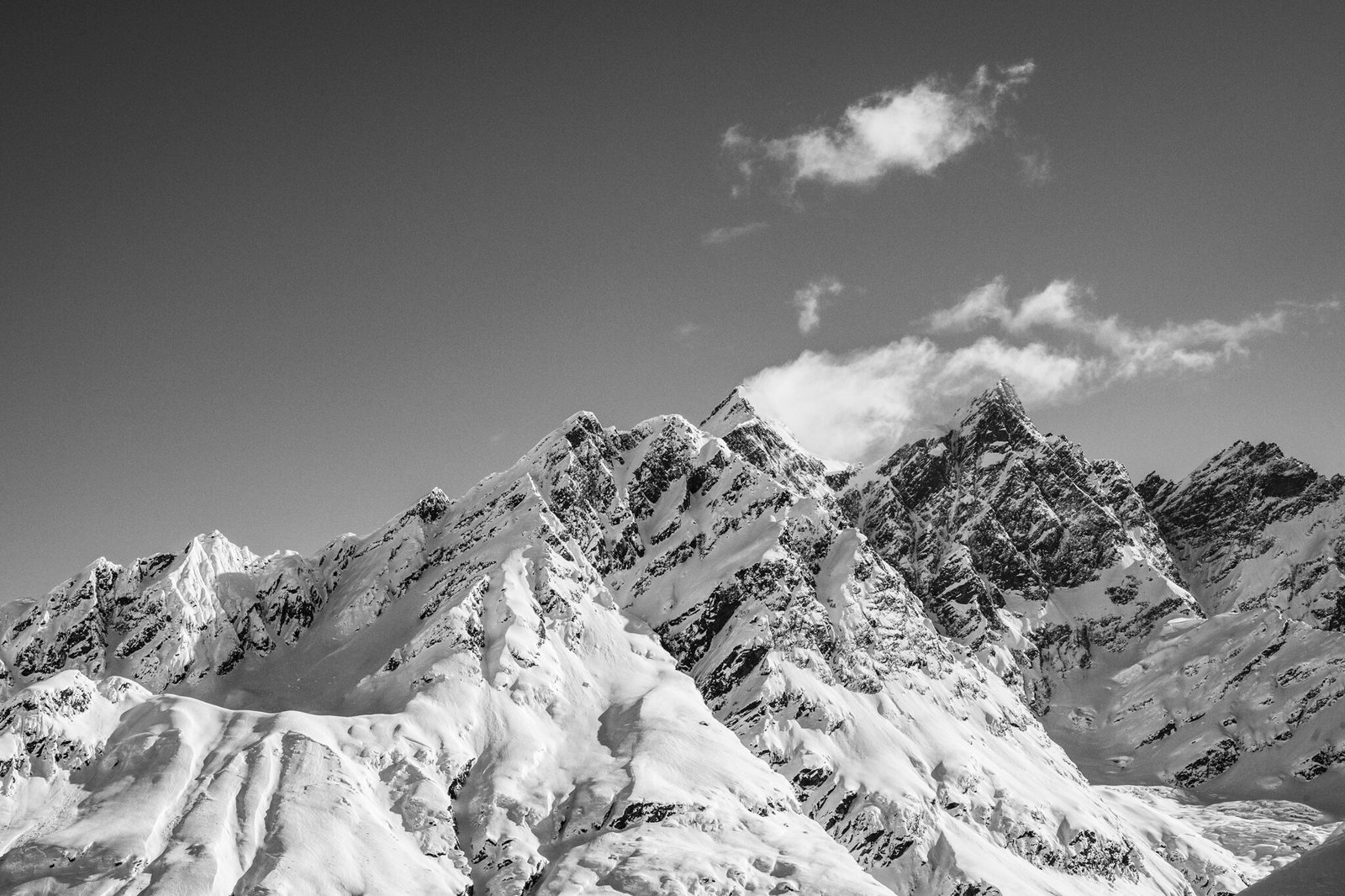 A skier riding a big-mountain line in the Chugach Mountains with Valdez Heli-Ski Guides