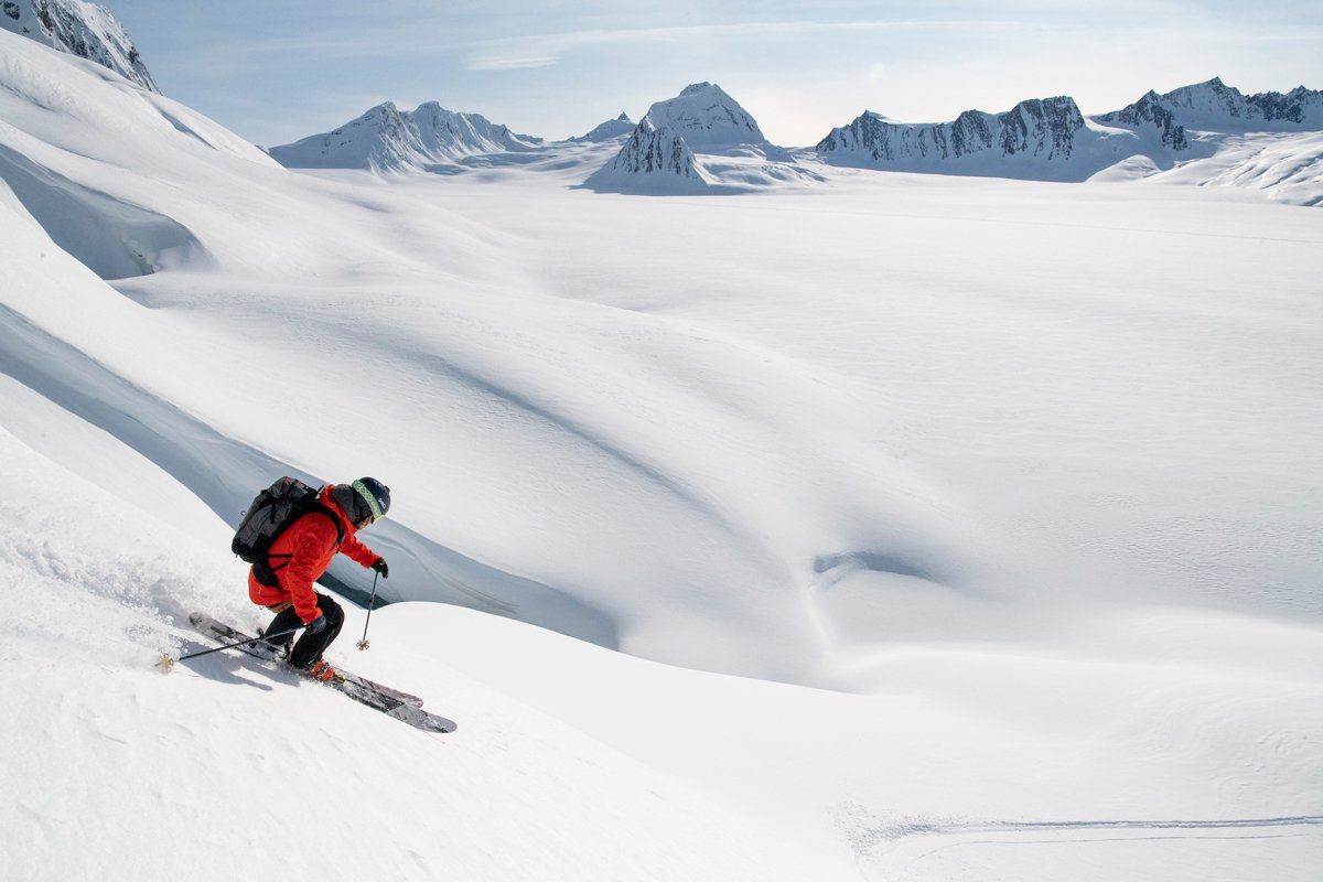A skier riding deep powder below the Chugach peaks, Valdez, Alaska