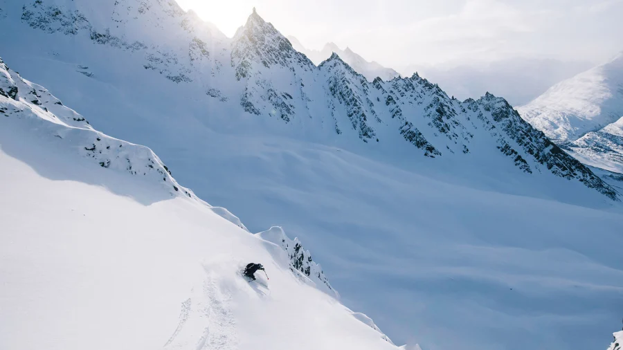 A skier carving deep powder in the Chugach Mountains, Valdez, Alaska