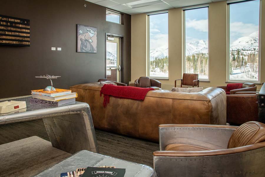 Cigar room with a fireplace at the Tsaina Lodge