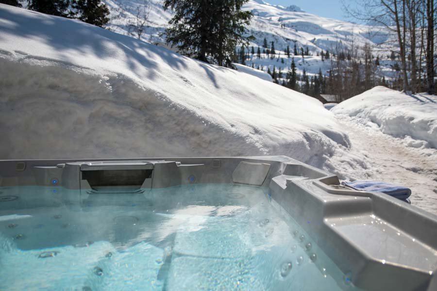 Outdoor hot tub steaming in the snow at the Tsaina Lodge