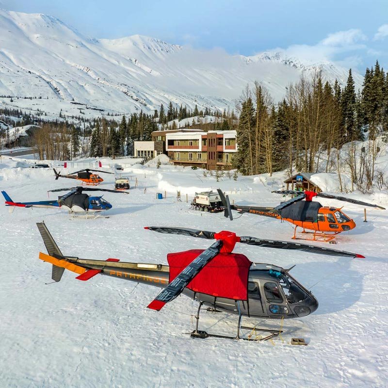 The Tsaina Lodge with helicopters parked out front, ready for a day of heli-skiing in the Chugach Mountains, Alaska