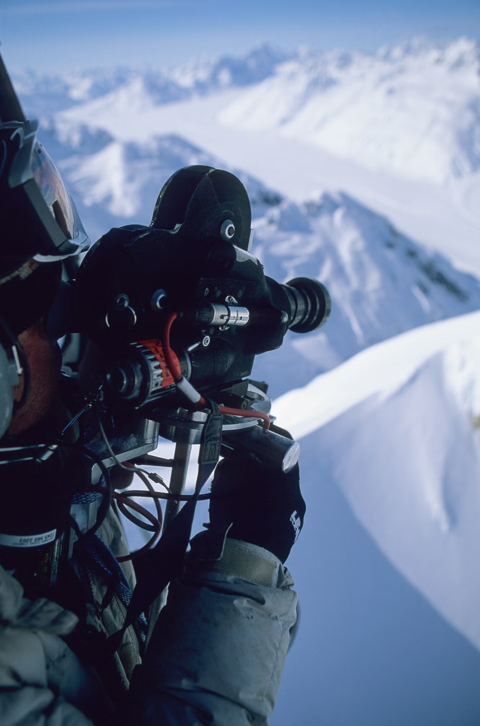Todd Jones of Teton Gravity Research filming from a helicopter with the doors off, Alaska 2001