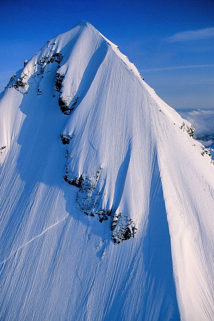 Skiers on the 45-degree ridge of Pontoon Peak, Chugach Mountains, Alaska