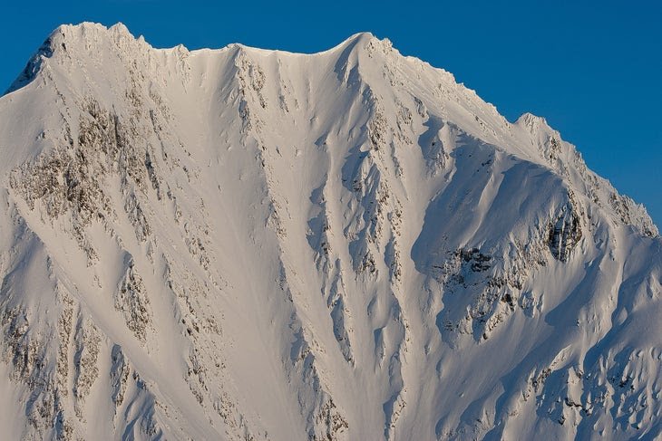 Two skiers descending the Dimond Peak couloirs simultaneously, Valdez, Alaska